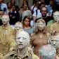 Artistas caminham pela Av Paulista com roupas sociais sujas com argila Artistas caminham pela Av Paulista com roupas sociais sujas com argila