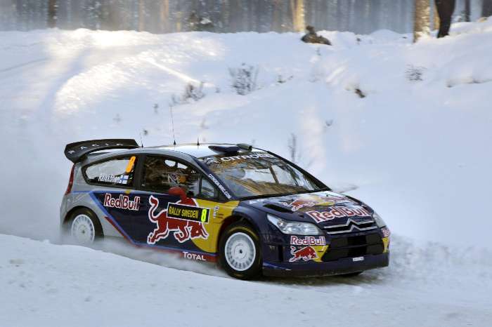 O finlandês Kimi Raikkonen contorna curva na neve com seu Citroen em etapa do Mundial de Rali