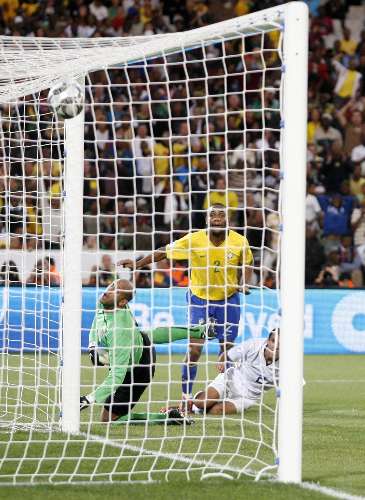 Maicon chuta a bola para marcar o terceiro gol do Brasil contra os EUA