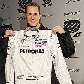 O alemão Michael Schumacher exibe o macacão com os patrocínios que utilizará na Mercedes