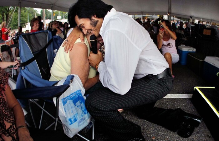 Artista presta tributo a Elvis fazendo uma serenata a uma das espectadoras em Memphis