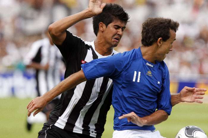 Thiago Ribeiro, do Cruzeiro, tenta impedir que atleticano lhe roube a bola