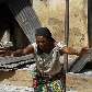 Mulher chora em frente a prédios queimados na vila de Dogo Nahawa, Nigéria Mulher chora em frente a prédios queimados na vila de Dogo Nahawa, Nigéria
