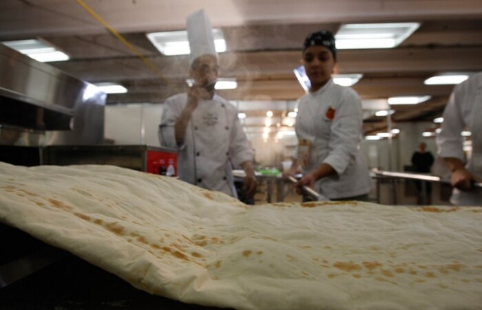 Pizzaiolo faz pizza gigante para celebrar o dia da iguaria 