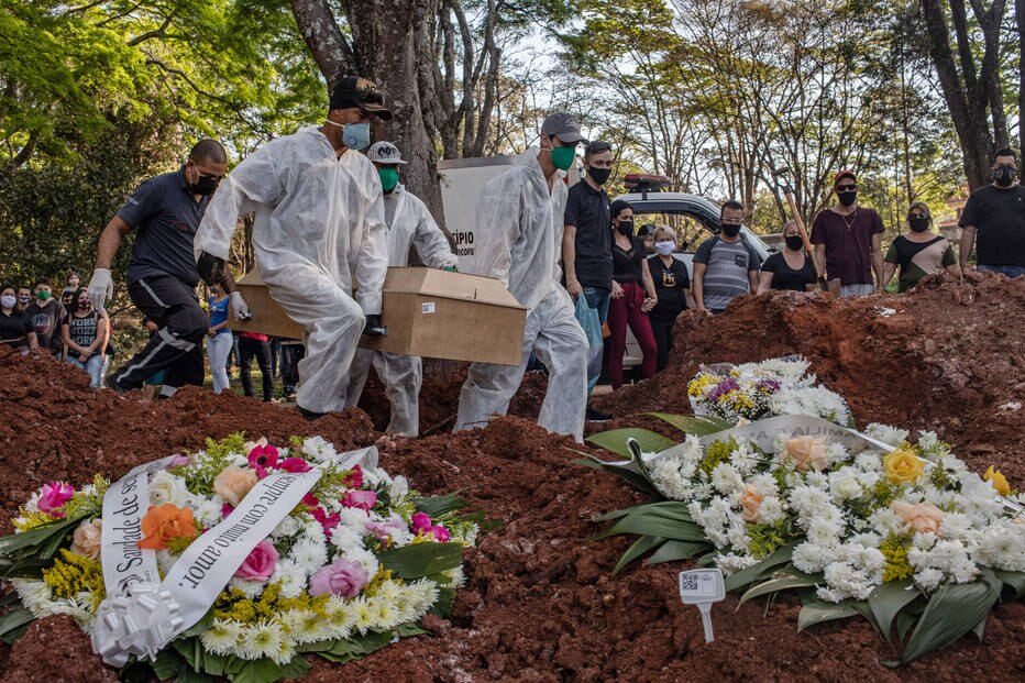 Coveiros realizam o enterro de uma pessoa que morreu pelo coronavírus, no cemitério de Vila Formosa, em São Paulo.