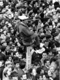 Torcedores se concentram no centro da capital paulista para assistirem à estreia da Seleção Brasileira na Copa do Mundo de 1970. Destaque para o torcedor que se acomodou em placa publicitária de um ponto de ônibus, 3/6/1970.