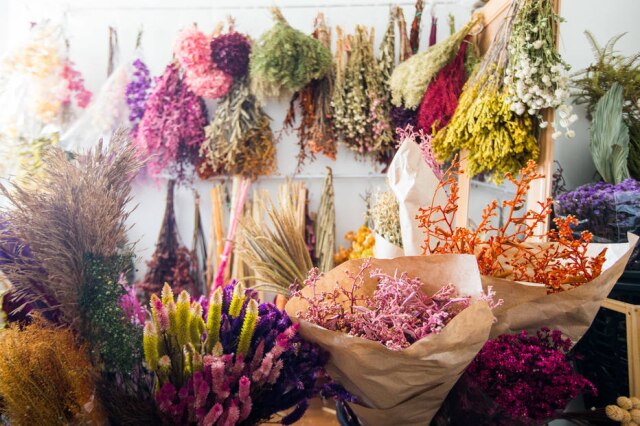Tiago Queiroz/Estadão Diferentes tonalidades dominam o ateliê da designer floral Suelen Grana. Entre as folhas e folhagens secas, algumas tingidas, outras naturais