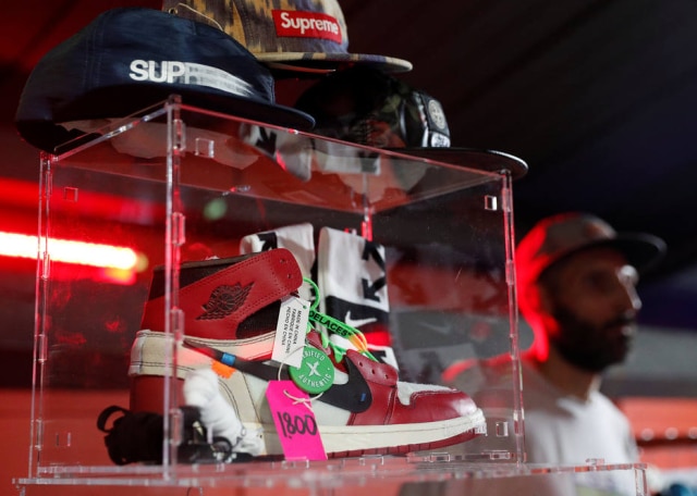 Alessandro Bianchi/Reuters Uma das criações de Virgil para a Nike, o Nike Off-White Air Jordan 1, com preço de revenda de 1.800 euros no mercado Kickit, em Roma. Lançados com distribuição e tiragem limitadas, muotos dos moidelos assinados por ele são considerados espécie de obras primas entre colecionadores