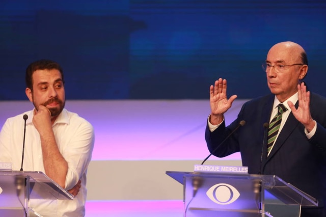 NILTON FUKUDA / ESTADAO Guilherme Boulos e Henrique Meirelles durante o debate presidencial da Band