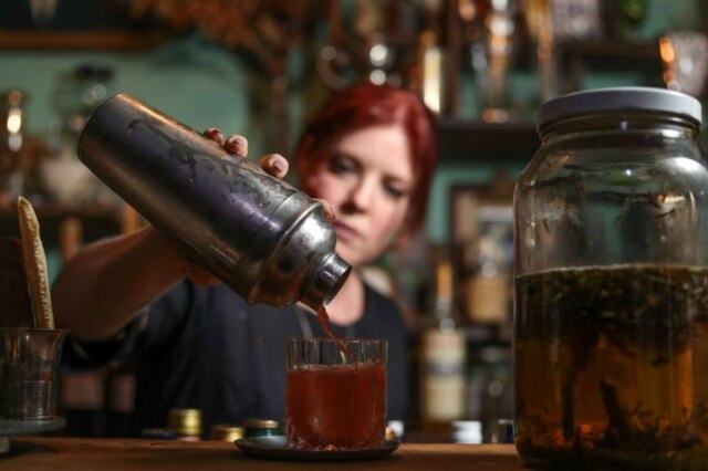 Gabriela Biló|Estadão Neli prepara o drinque Levante, com garrafada de catuaba e ervas que faz na casa