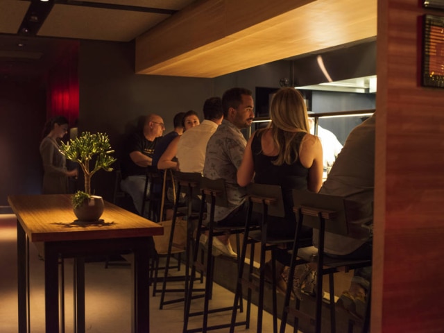Cole Wilson/NYT O bar é um laboratório onde os comensais podem assistir os cozinheiros criando pratos.
