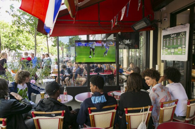 GIO STAIANO/ THE NEW YORK TIMES Fora das passarelas, modelos assistem a um jogo da Eurocopa