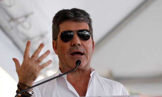 FILE PHOTO: Producer Simon Cowell speak at the Hollywood Walk of Fame in Los Angeles, California U.S., March 22, 2017. REUTERS/Mario Anzuoni/File Photo