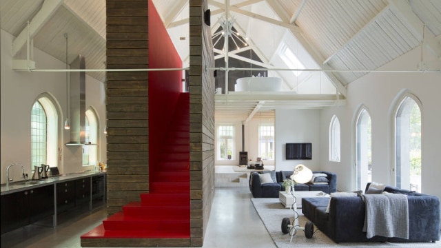 Andreas Meichsner/NYT A white interior of the former nave is punctuated by a red staircase to the master suite on the second floor in the church converted into a home by Ronald Olthof and his partner, Sofie Suiker, in Haarlo, Netherlands, May 30, 2014. The couple intended to convert an old factory into a home, but after a deal fell through, they ended up buying the church instead. (Andreas Meichsner/The New York Times)