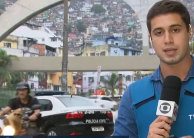 Reprodução RJTV/Globo Gato de ósculos escuros 'invade' reportagem do RJTV.
