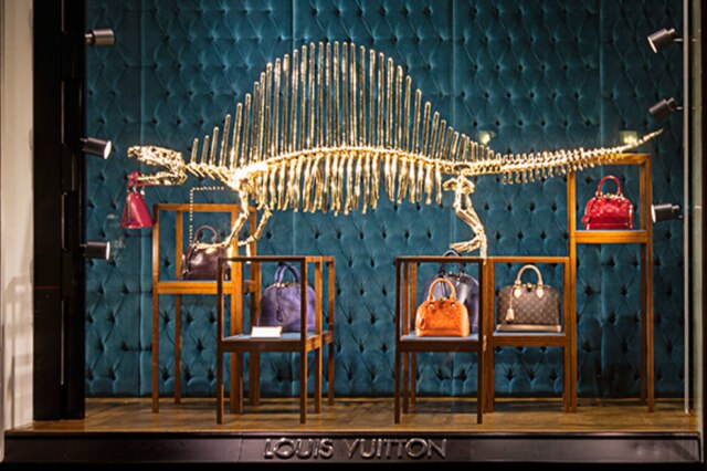 Reprodução Fachada de uma loja da grife Louis Vuitton com algumas de suas bolsas mais icônicas