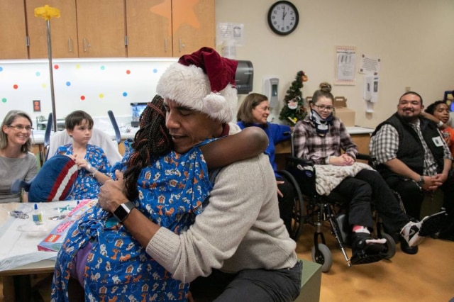 Chuck Kennedy / The Obama Foundation / AFP Barack Obama abraça paciente de hospital infantil em Washington.